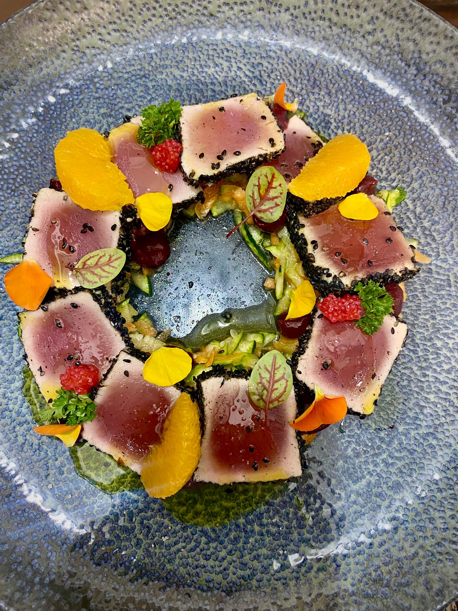 Tataki di tonno scottato in crosta di sesamo nero, con agrumi, germogli e frutti di bosco